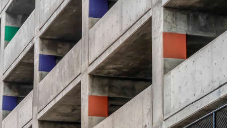 Panorama frame Covered parking lot of a concrete building viewed from outside on a cloudy dayの写真素材