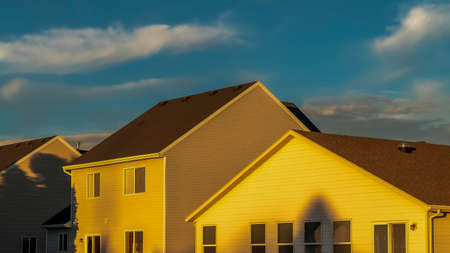 Panorama Houses with horizontal wall siding and outdoor stairs leading to the balconies