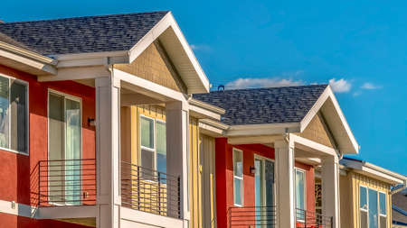 Panorama Homes with combination of red and cream exterior wall against sky on a sunny day
