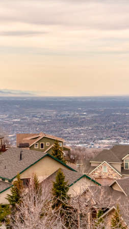 Exterior of homes with view of the vast valley and mountain in the background. A sky covered with...