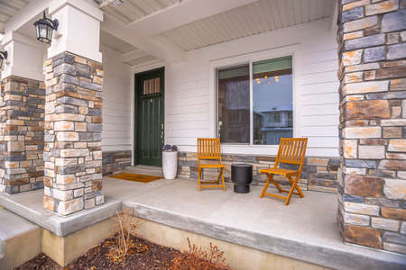 Front porch glass paned door yard and outdoor stairs at the facade of a home