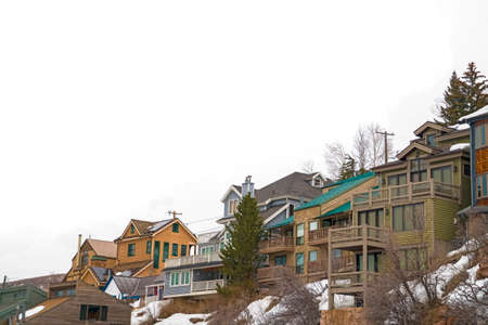 Winter season in Park City Utah with cabins and houses on snow covered mountain. Conifers and trees...
