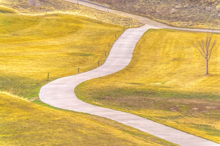 Footpath or cycle path winding over rolling hillsの写真素材