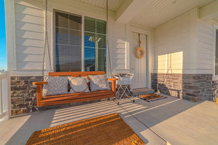Front veranda of modern home with swinging chair