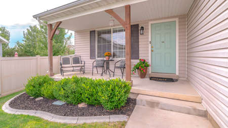 Panorama frame Front porch of modern home with landscaped garden. The front porch and door of a...