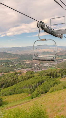 Vertical Mountain landscape during summer in Park City Utah with focus on chairliftsの写真素材