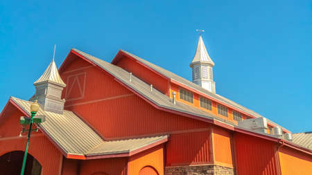 Panorama frame Colorful orange barn at a vinyard with clear blue sky background on a sunny dayの写真素材