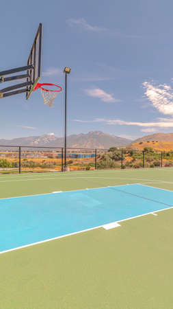 Vertical Outdoor basketball court and nets on sunny dayの写真素材
