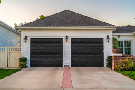 Double garage with short driveway in day. Double garage with short driveway off an urban street attached to a residential propertyの写真素材