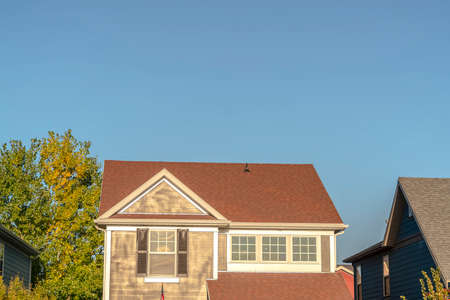 Modern home with sash window and shutters. Modern two storey home with face brick finish, sash window and shutters in a close up cropped view in evening lightの写真素材