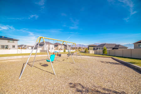 A-frame swings in a kids playground during day