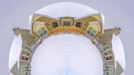 Panorama Circular design made from a winter village with fresh snow covering everything and white...