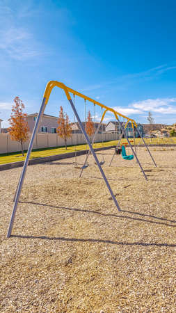 Vertical frame Set of A-frame kids swings in a residential parkの写真素材