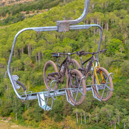 Square Close up of chairlifts with mountain bikes in Park City ski resort at off season. Lift accessed mountain biking with hiking trails in summer.の写真素材