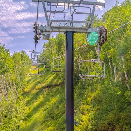Square frame Ski resort mountain landscape with chairlifts and hiking trails at off season. Scenic views in Park City, Utah on a sunny day in summer.の写真素材