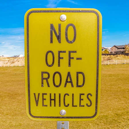 Square frame Road sign on a grassy field - No Off-road vehiclesの写真素材