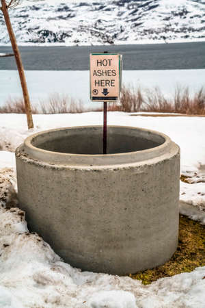 Scenic winter landscape at a park with close up of a circular pit with ashesの写真素材