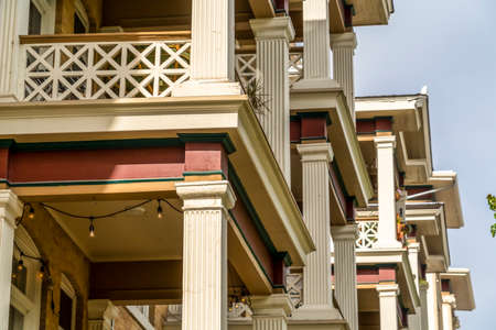 Close up of square columns and lattice railing framing the balcony of townhomesの写真素材