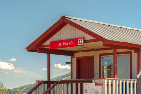 Ski Patrol building with stairs going to porch and red front door in Park City. Scenic views at a...