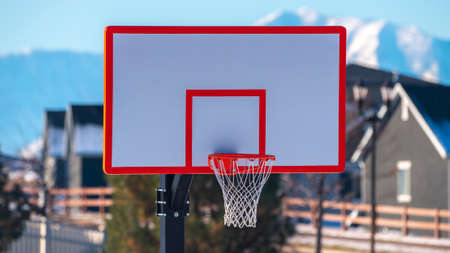 Panorama Colorful red framed basketball net and goalpost near sunset