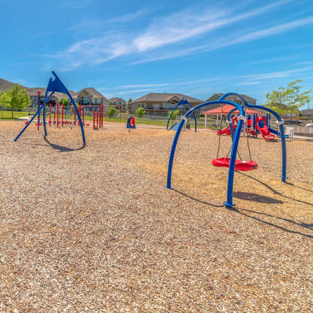 Square Pavilion and childrens playground at a park against scenic Timpanogos Mountains. Colorful...