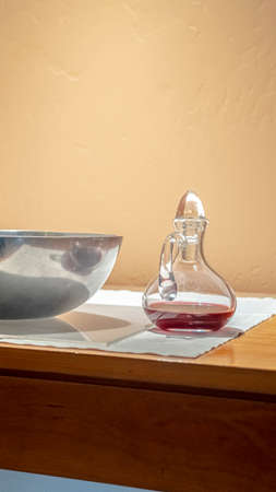 Vertical Red wine and bowl of wafers for Communionの写真素材