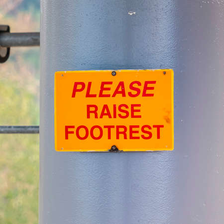 Square frame Please Raise Footrest sign on chairlifts in Park City Utah viewed at off seasonの写真素材