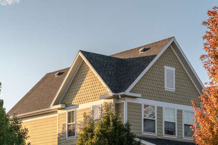 Modern timber clad house with decorative textured patterned wall under the eaves in the pitch of the...