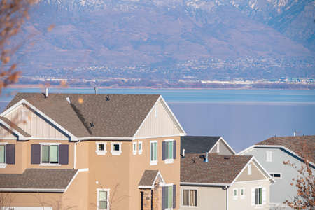 High angle view on the street of traditional American single family houses against Utah lake in the distanceの写真素材