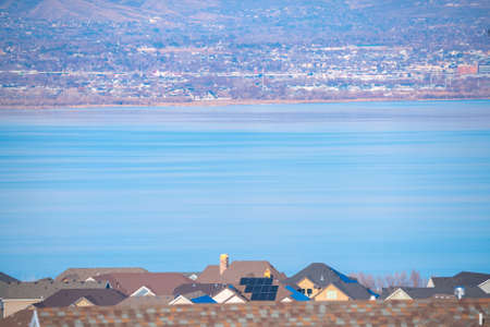 Utah Lake viewed over the rooftops of housesの写真素材