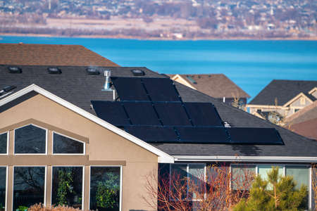 Contemporary urban house with rooftop solar panels to provide renewable green energy with the Utah...