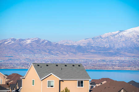 View of the Utah Lake and snowy mountains past the upper floor of a modern home in the Utah valleyの写真素材