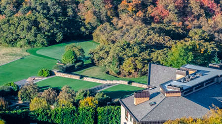 Panorama Roof of a resort complex in a valley in autumn or fall with colorful foliage on the treesの写真素材