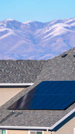 Vertical Photovoltaic solar panel on a house roof in the Utah Valley for sustainable energy with...
