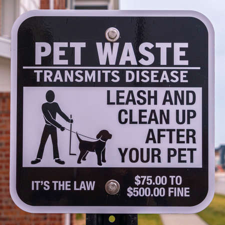 Square frame Pet Waste Transmits Disease warning notice or signpost at an apartment complex asking owners to clean upの写真素材
