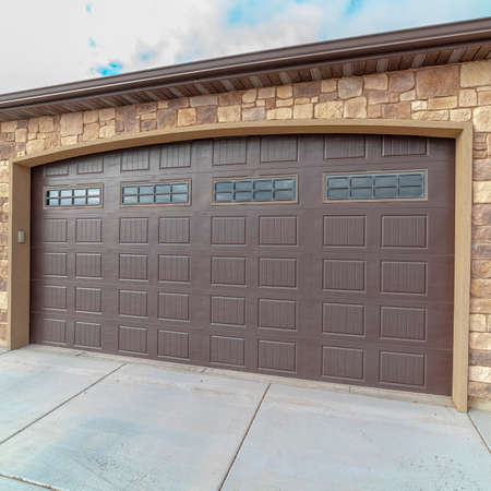 Square frame Large closed double wooden garage door day lightの写真素材