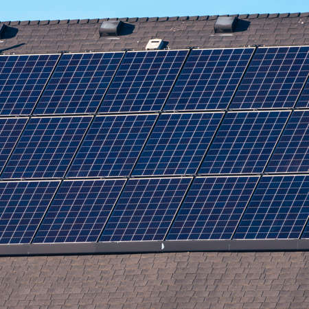 Square frame Array of solar panels on a house roof in close upの写真素材