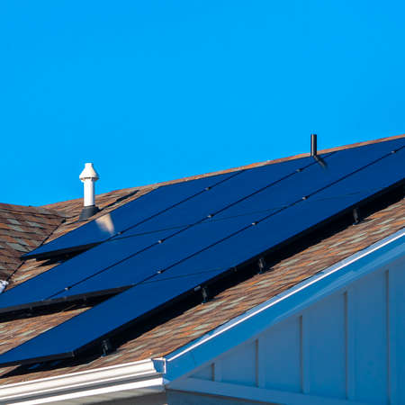 Square frame Snow and photovoltaic solar panels on a roof
