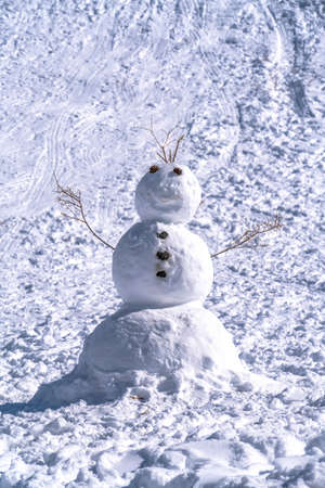 Jolly man made snowman sitting on the snowy hills of Park City Utah in winterの写真素材