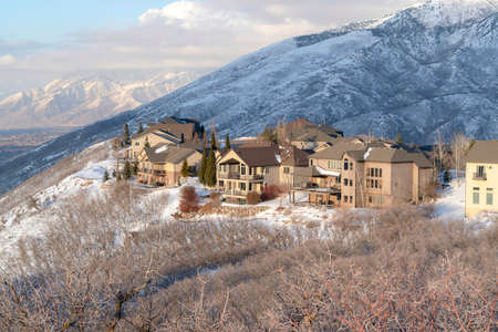 Winter in Utah with snowy Wasatch Mountains and lovely mountain homes views. The neighborhood is...
