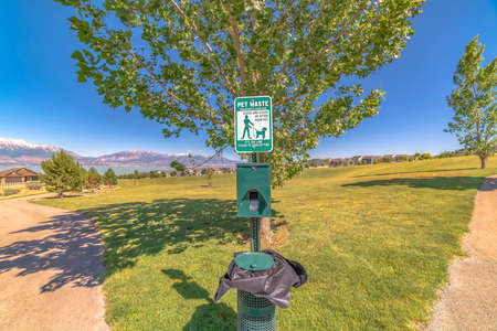 Dog poop bags and garbage can against timpanogos mountains and blue lakeの写真素材