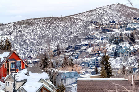 Park City Utah mountain in winter with colorful homes that sit on snowy slopes. The frosted...