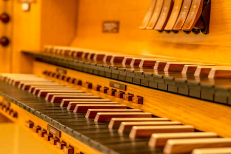 Close up of a beautiful piano with wooden keyboard and protective caseの写真素材