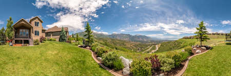 Panorama of the backyard of home with landscaped grassy lawn and lush plants. 360 degrees views of backyard with Timpanogos mountain in the background.の写真素材