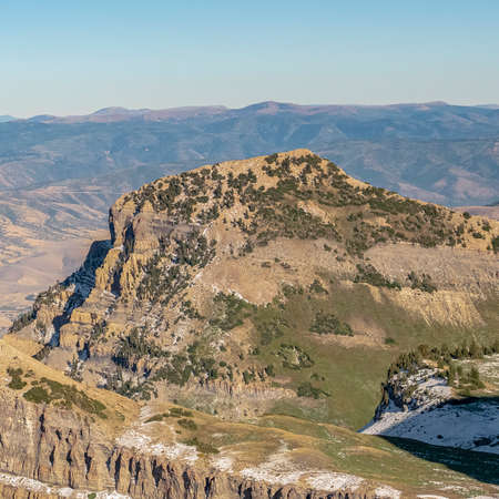 Square crop Scenic view of summit of Mount Timpanogos, Utah with light dusting of now on the steep slopesの写真素材