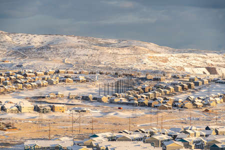 Scenic Utah Valley community blanketed with winter snow under overcast gray sky. Houses and hills can be seen in this picturesque landscape.の写真素材