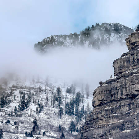 Square crop Scenic Provo Canyon scenery with Bridal Veil Falls under sky with thick clouds. The beautiful waterfall is frozen on this cold winter day.の写真素材