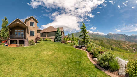 Panorama frame Panorama of the backyard of home with landscaped grassy lawn and lush plants. 360 degrees views of backyard with Timpanogos mountain in the background.の写真素材