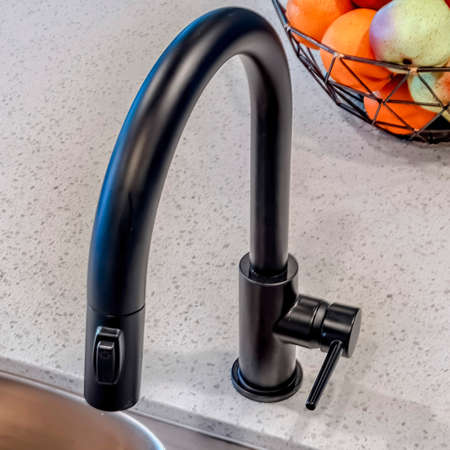 Square frame Curved gooseneck shaped black faucet over kitchen island sink with double bowls