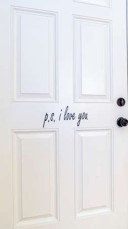 Vertical White closed interior wooden door in a blue wall with skirting in a residential home